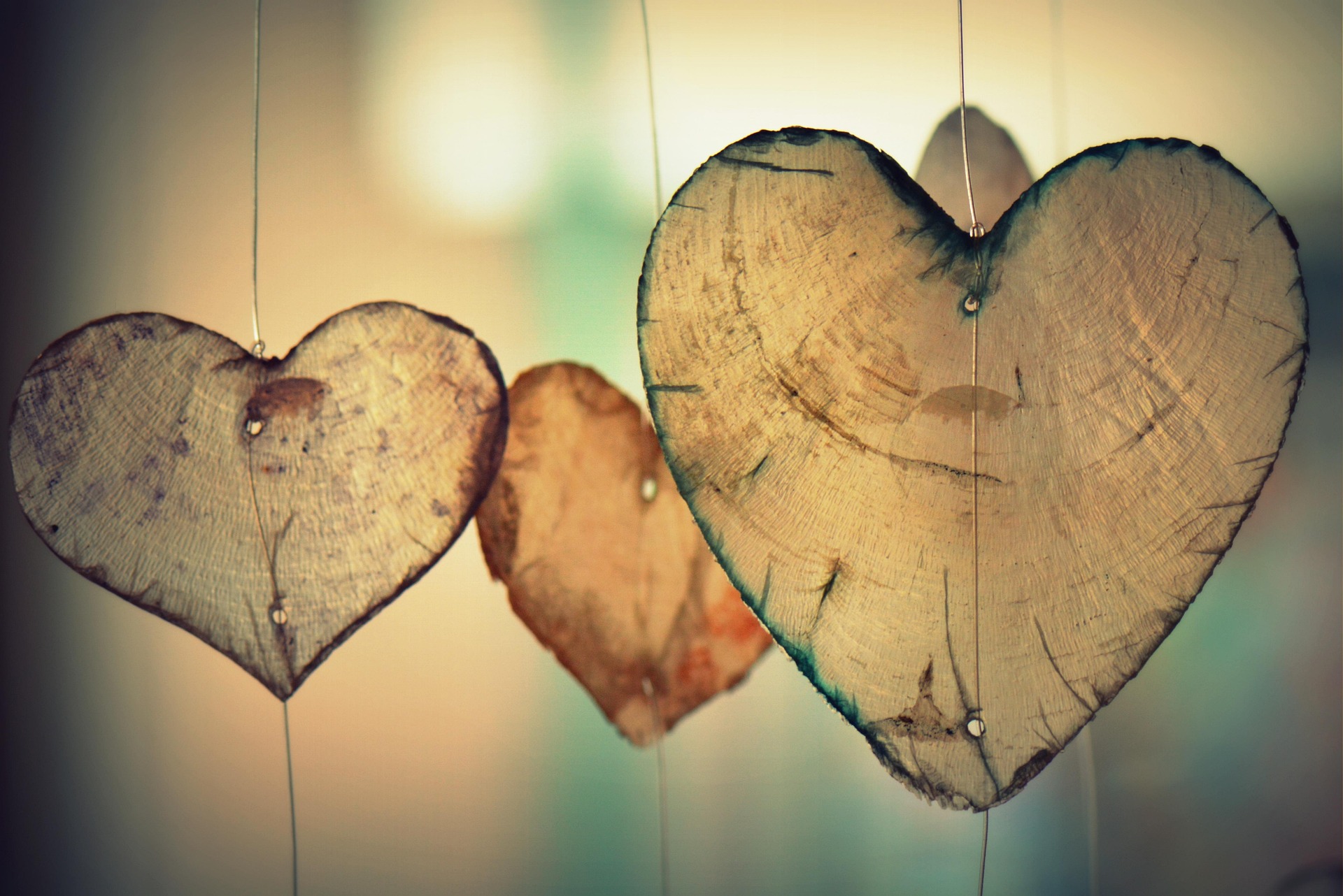Wooden heart ornaments hanging on fine wire