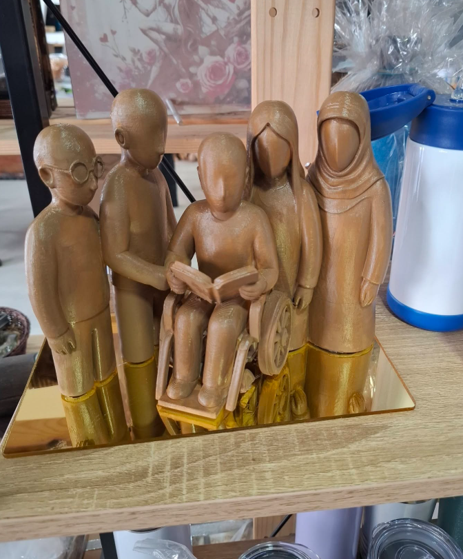 Sculpted keepsake of five figures on a mirrored base